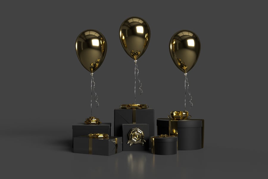 Gold Balloons and Gift Boxes on Black Background
