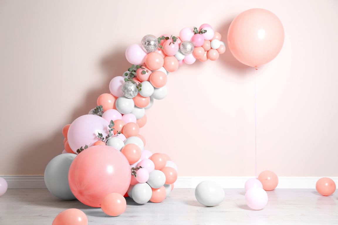 Balloon Garland near Beige Wall in Room. Festive Decor